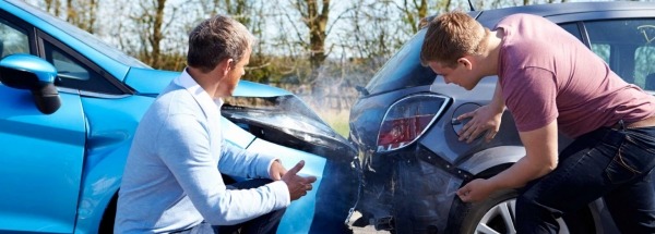 2 mannen bekijken de schade aan hun auto,s 